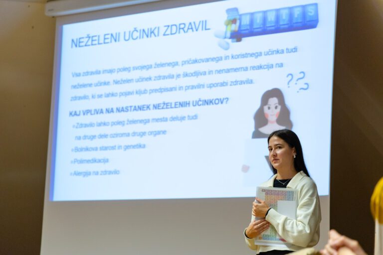 Predavateljica pred projektorskim platnom